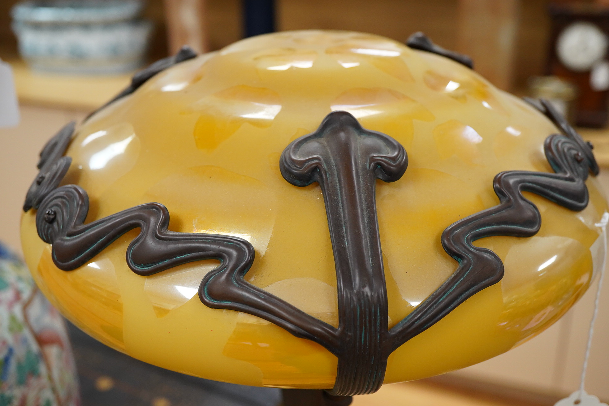 In the manner of Gustav Gurschner, an Art Nouveau style figural bronze lamp with yellow etched shade, 58cm